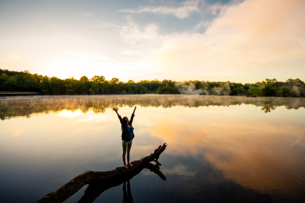 woman on branch in water