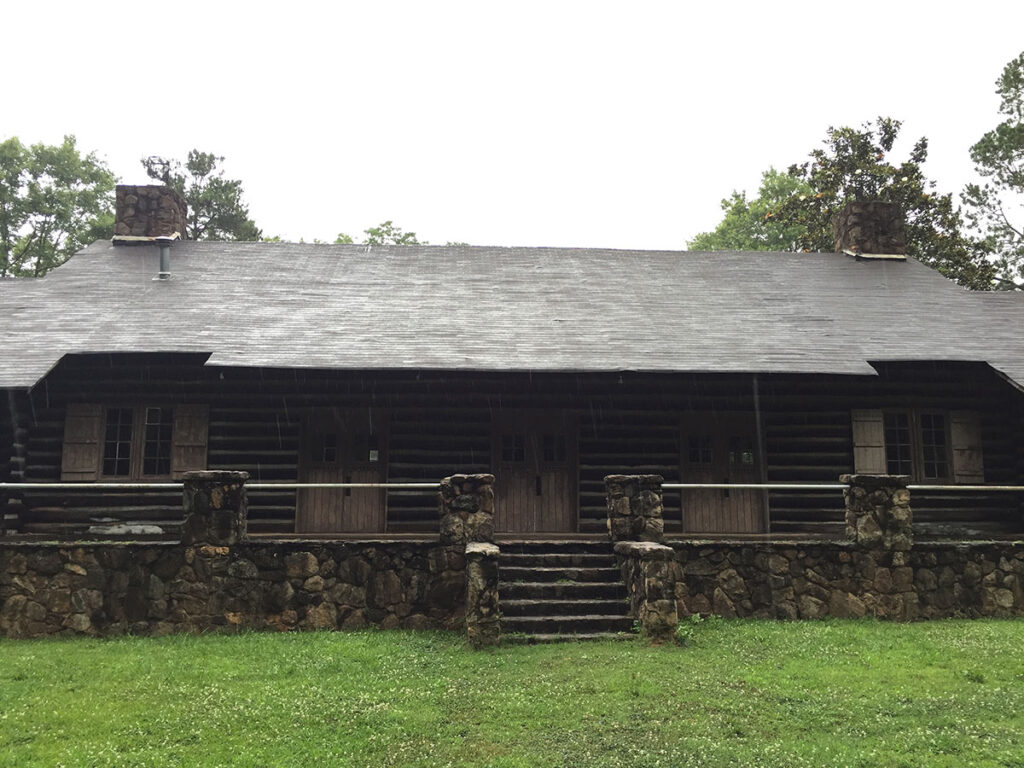 Old log building with stonework foundation and stairs