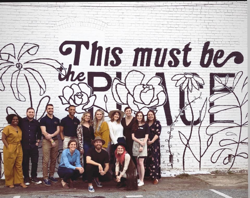 People in front of mural