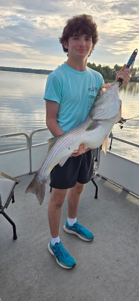 A younger guest on All Seasons Guide Service holding up a large fish.