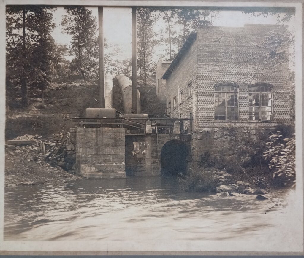 black and white photo of water powered power house