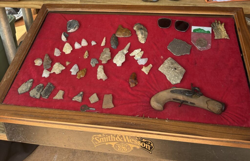 display case of arrowheads and other artifacts