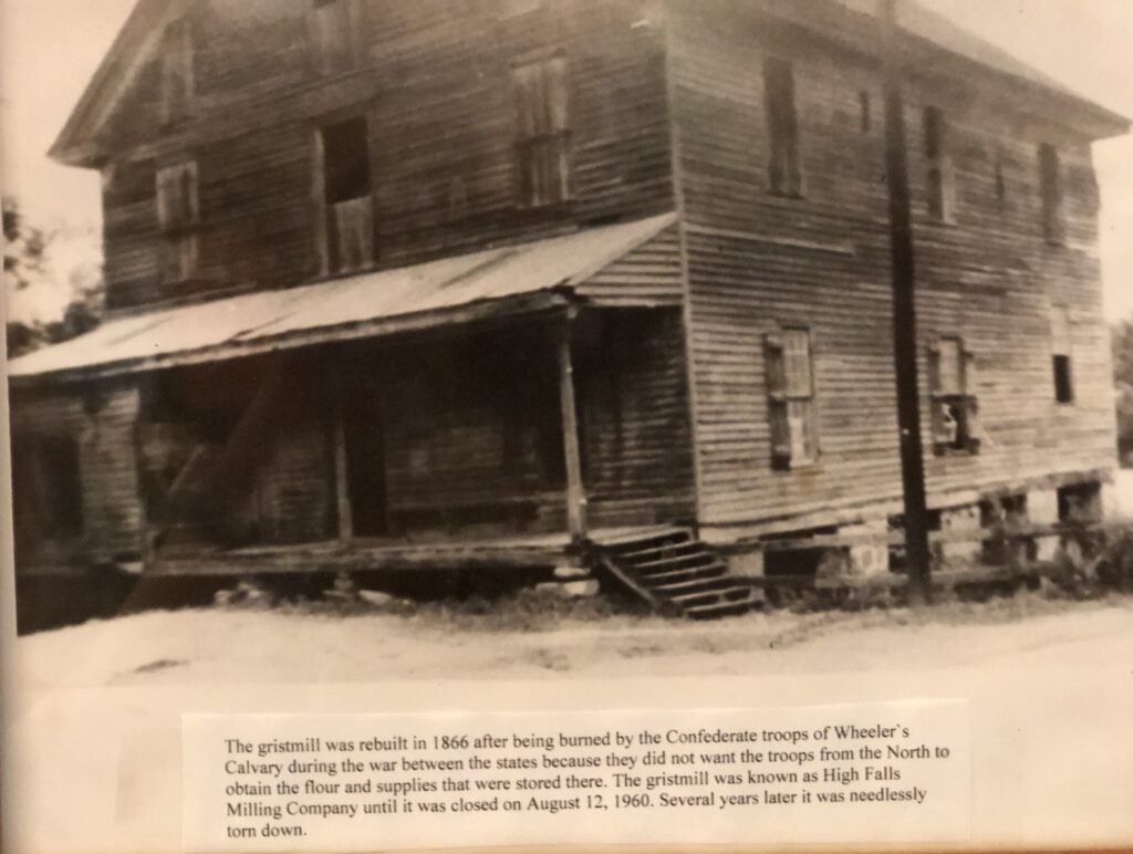 black and white photo of 2-story wood building with front porch - 1866 grist mill at high falls, georgia