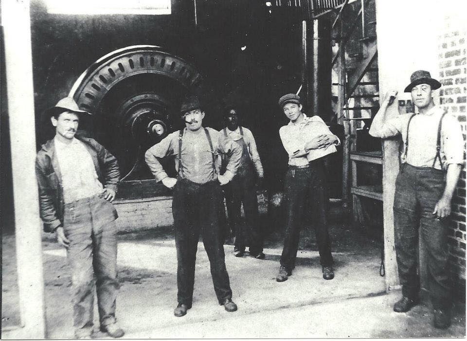 black and white photo of work men in suspenders at High Falls power plant