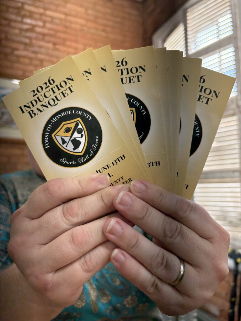 tickets for sports hall of fame fanned out in a person's hands