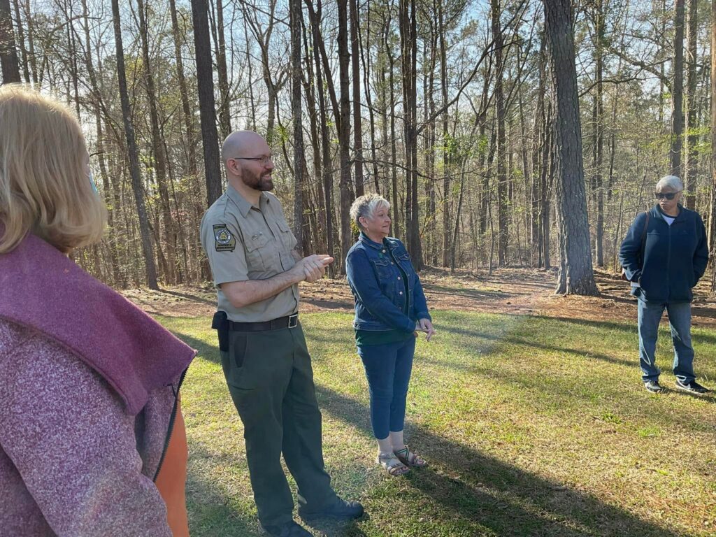 park ranger talking to a group of women in a forest