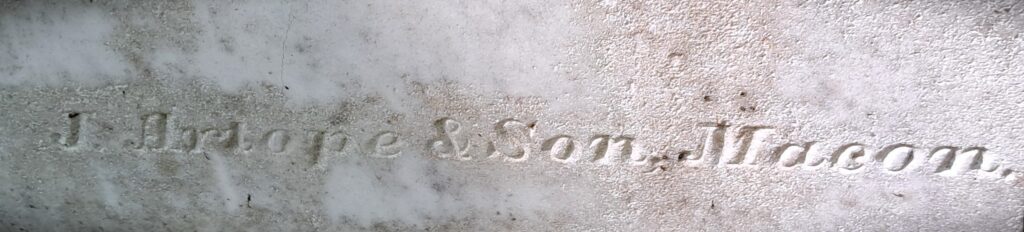 close up carved text on marble headstone