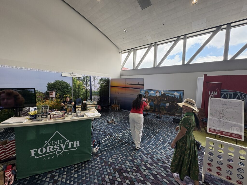 Mom takes photo of child in photo op in Visit Forsyth GA booth