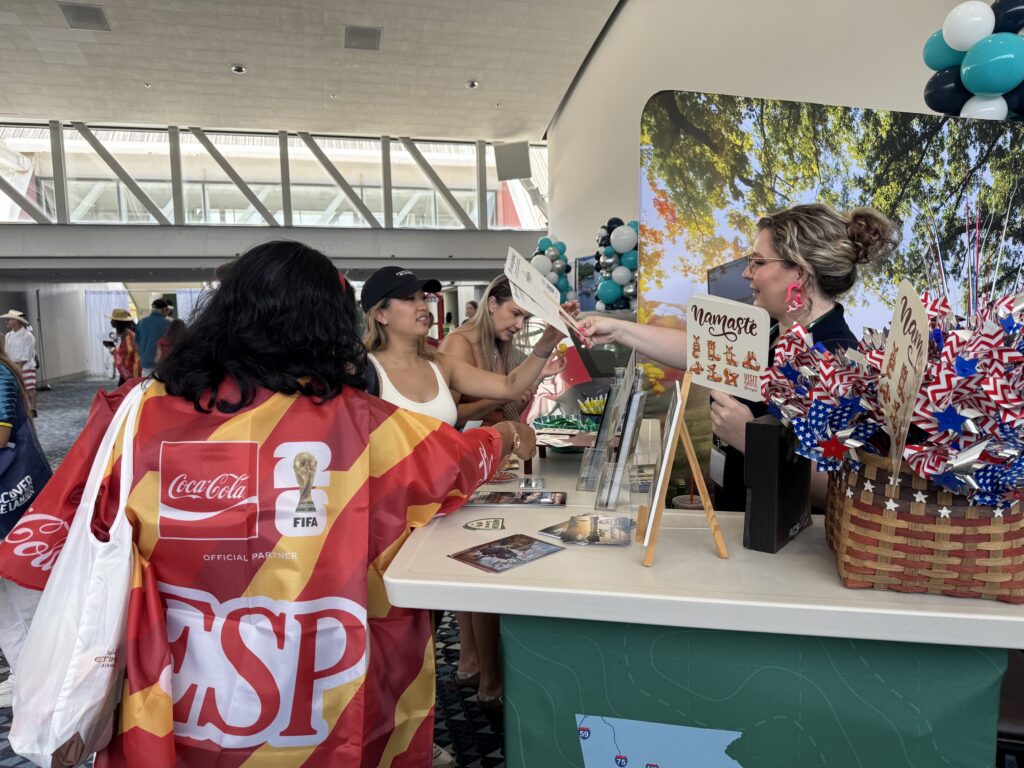 world cup fans getting information from Visit Forsyth GA booth