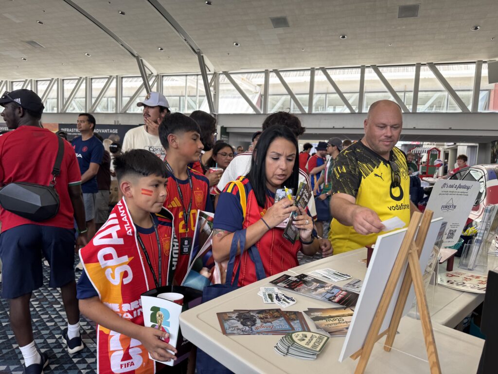 world cup fans getting information from Visit Forsyth GA booth
