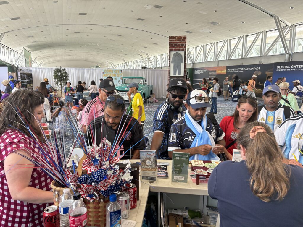 World cup fans in front of Visit Forsyth GA booth