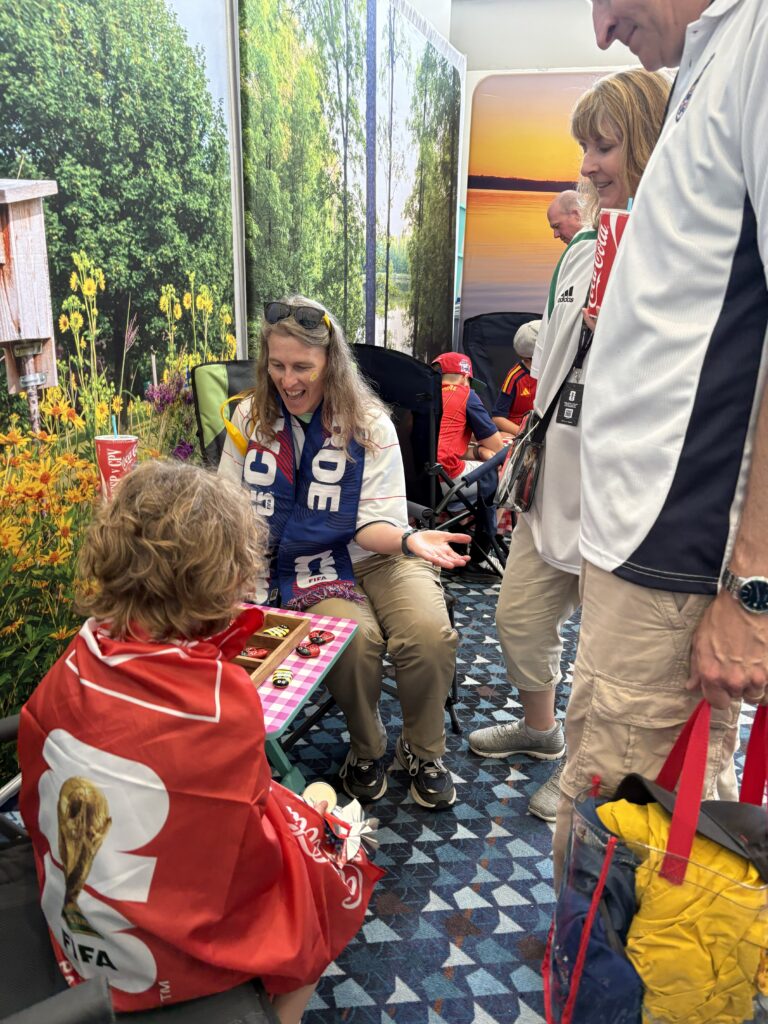 World Cup fans play checkers in Visit Forsyth GA booth