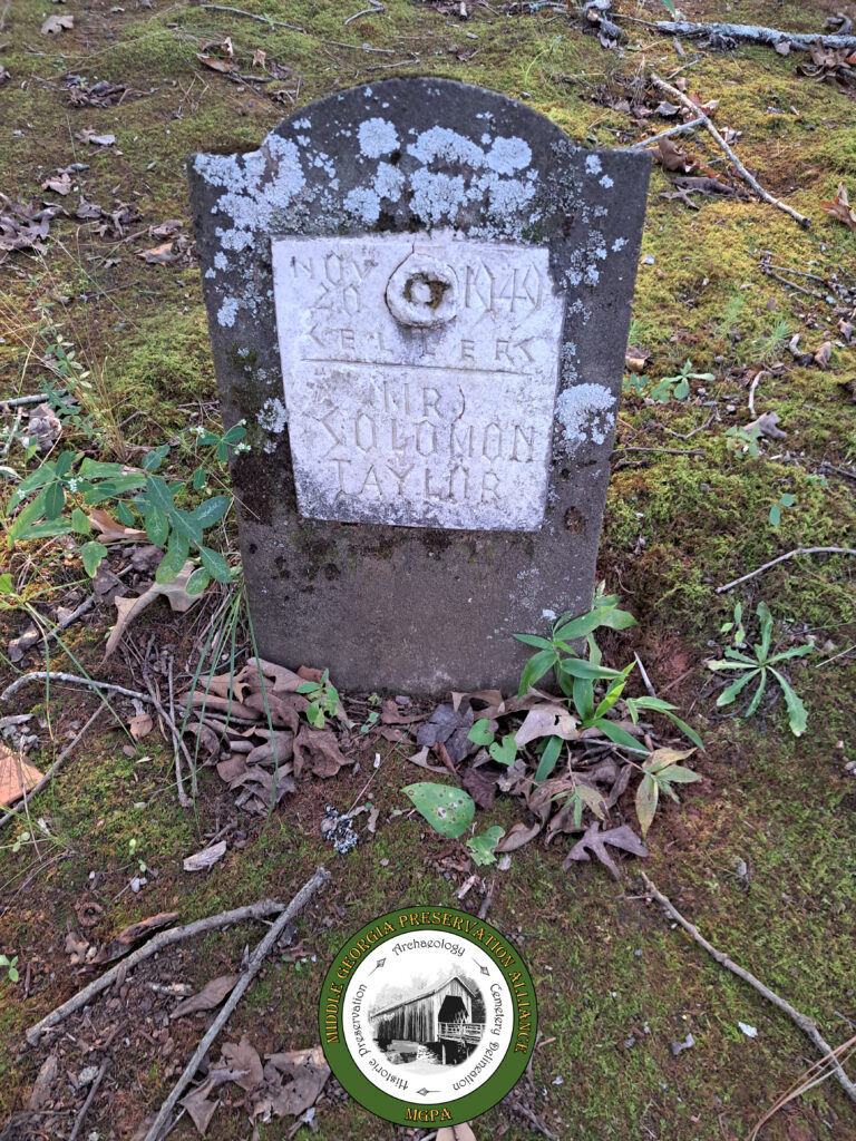 concrete headstone with plaster face carved with names and dates