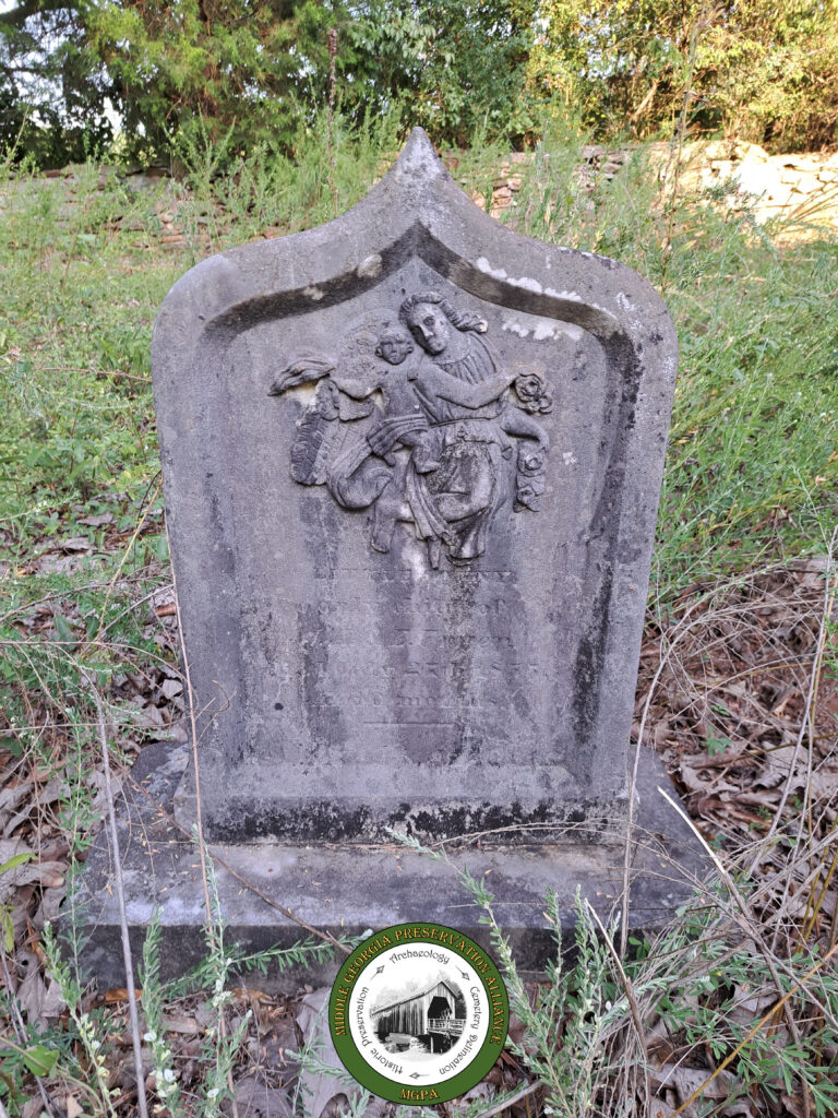 headstone with carved design of mother and child