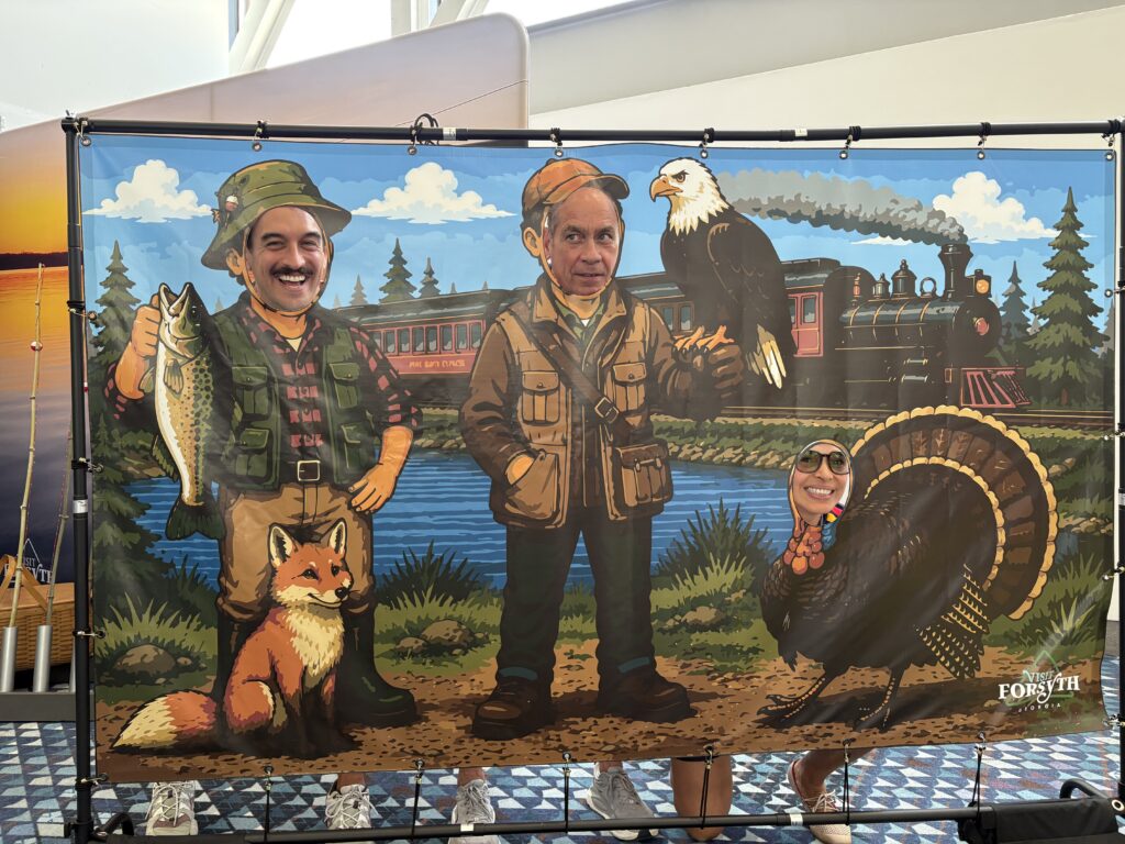 World cup fans pose in photo op at Visit Forsyth GA booth