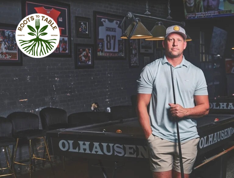 Owner Casey McCrea stands in front of pool table inside his restaurant and entertainment business Driven Sports Lounge